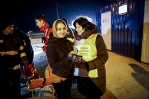 Star of Hope volunteer handing out supplies to refugees in Romania.