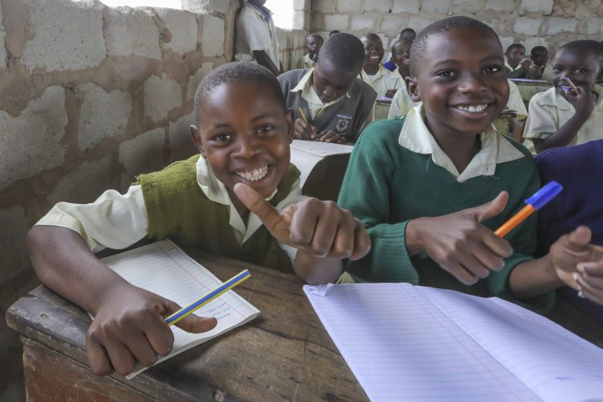 Glada barn i Jimba, Kenya gör tummen upp